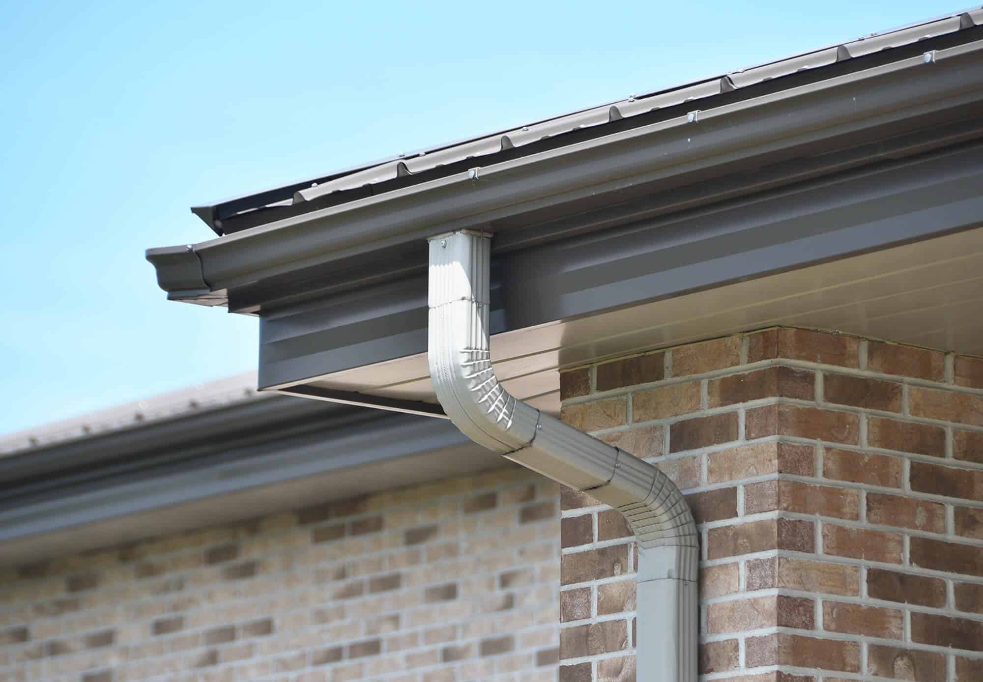 Side view of house with pipe from roof gutter