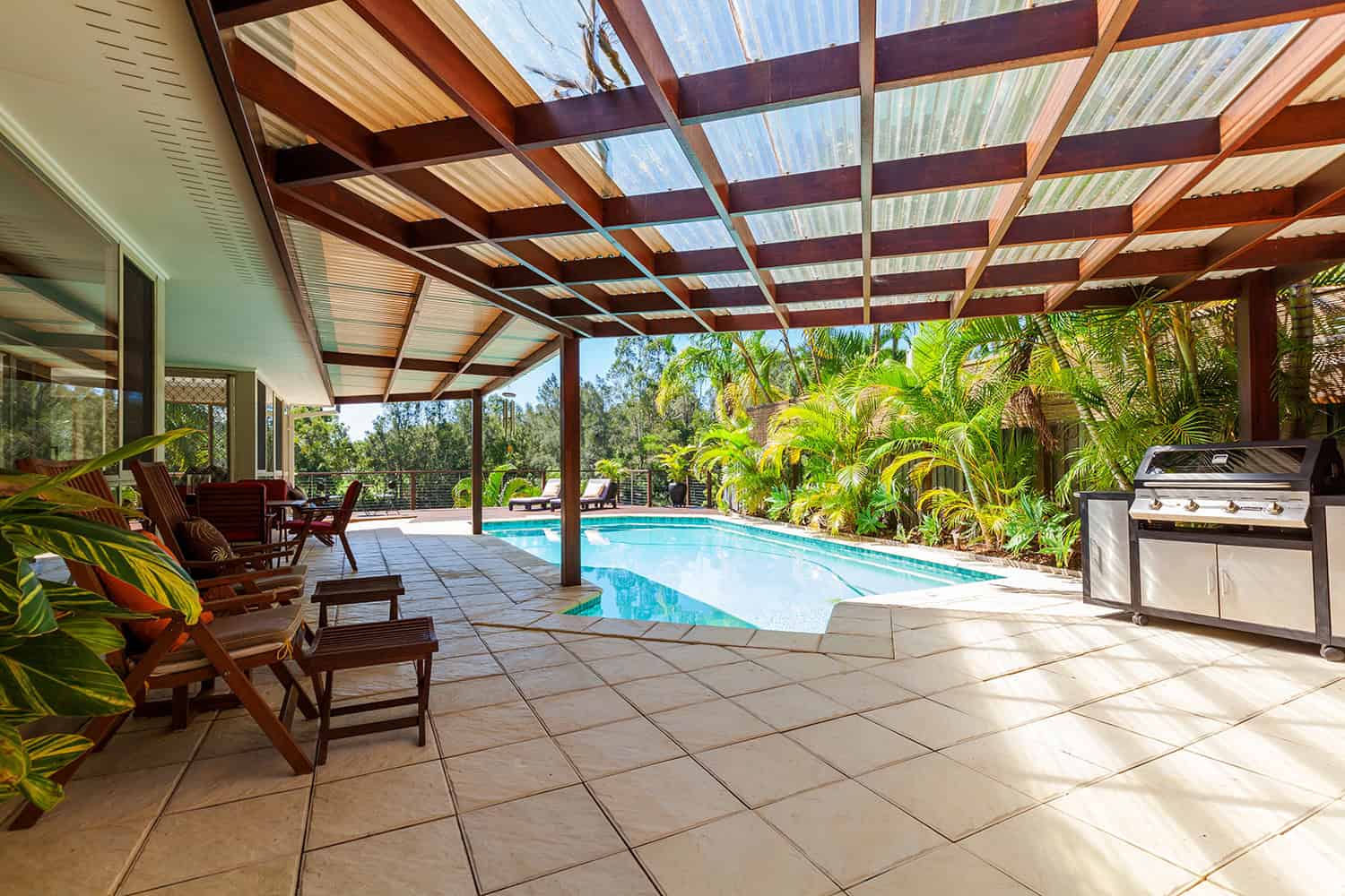 Backyard with a patio cover made of wood and translucent sheets